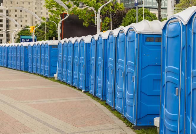 a line of portable restrooms at an outdoor wedding, catering to guests with style and comfort in Aurora, OH